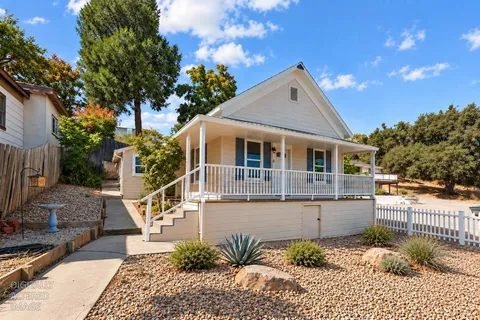 White cottage with a covered front porch