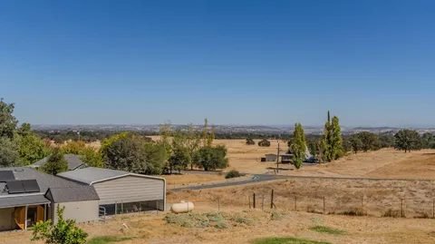 View across golden foothills from a country property