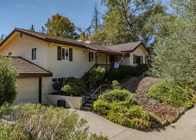 Single-story home with a tile roof and landscaped front yard