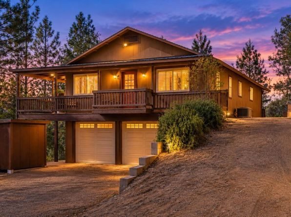Mountain home among pine trees at dusk
