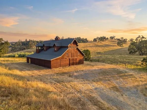 Red barn on golden rolling hills