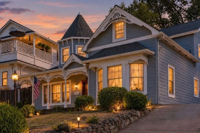 Victorian home with a turret at dusk